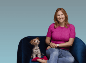 Portrait von Juliette Boisson mit hund auf dem Sofa sitzend.